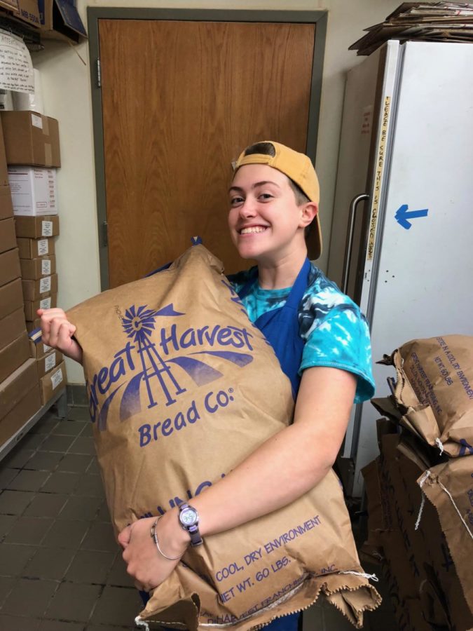 Holmgren, 19, poses with a bag of flour during a shift. 