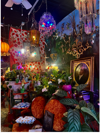 Pictured is the eclectic, vibrant interior of Hunt & Gather, located in Minneapolis. Colorful lights adorn the walls along with sparkling antiques. Would you stop in for a visit?